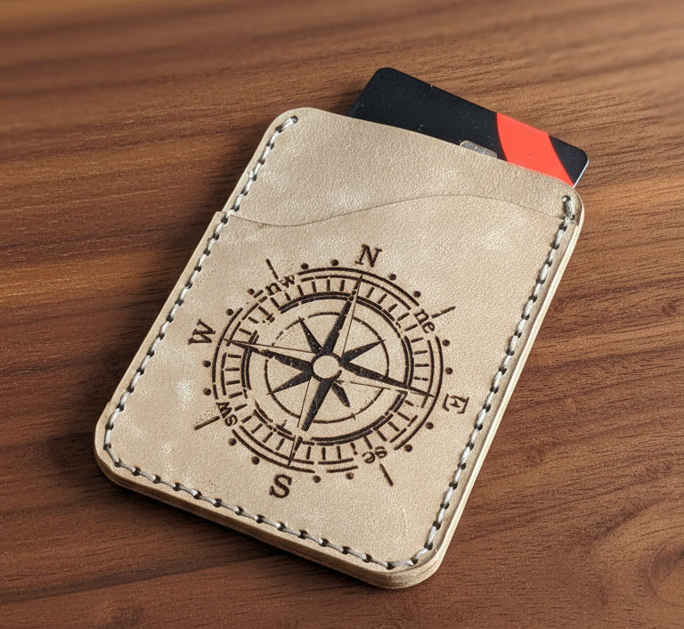 Compact Card Sleeve with compass engraving displayed with compass design on a wooden surface.