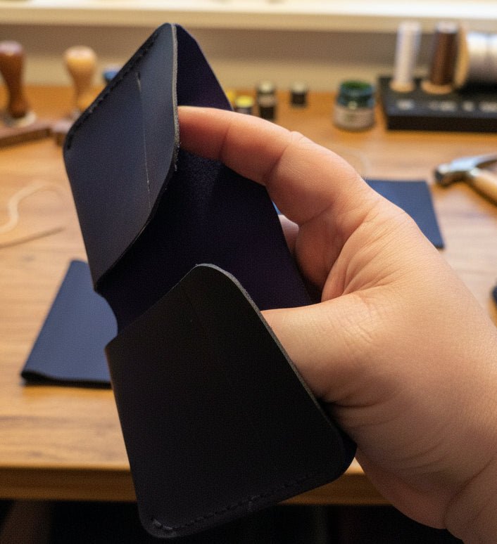 Alt Tag: Compact Bi-Fold Wallet handmade in Black held open, slim premium leather interior and card slots