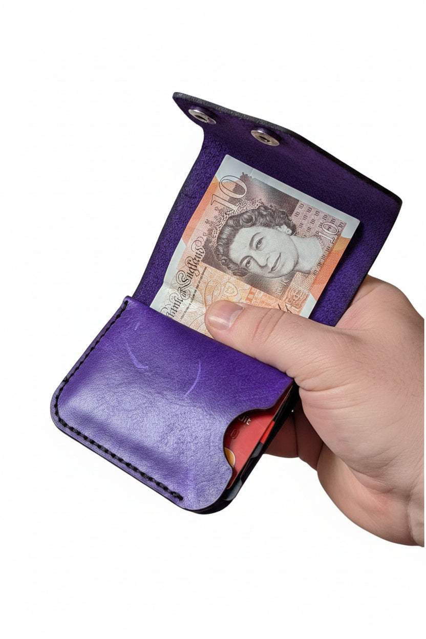 Compact Club wallet in hand-dyed full-grain leather with stitching, holding five cards and folded notes