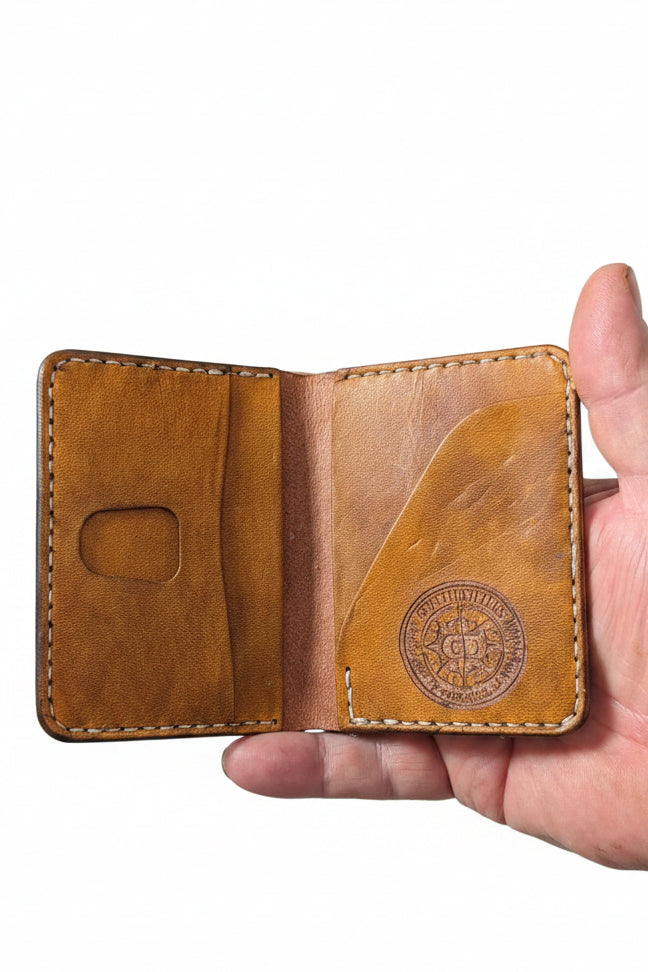 Low profile handmade bi-fold leather wallet crafted from full-grain leather with sleek design and multiple card slots