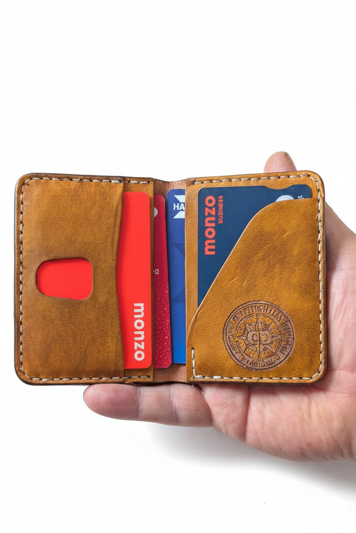 Low profile handmade bi-fold leather wallet crafted from full-grain leather with slim design and multiple card slots