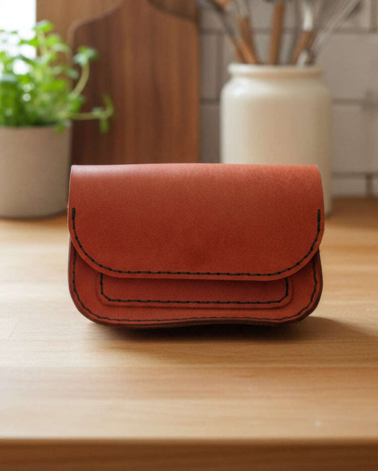 Card Purse Bag with large pocket and card slip in luxurious Italian leather on a wooden table.