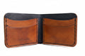 The Gribbon black and tan leather bi-fold wallet with four pockets and hand-stitched wax thread detailing