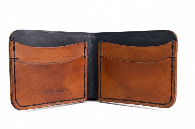 The Gribbon black and tan leather bi-fold wallet with four pockets and hand-stitched wax thread detailing